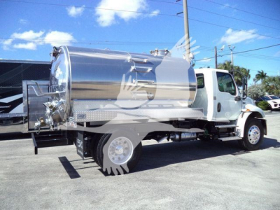 Vacuum tanker truck with stainless steel cylindrical tank mounted on a white truck chassis, rear loading connections visible.