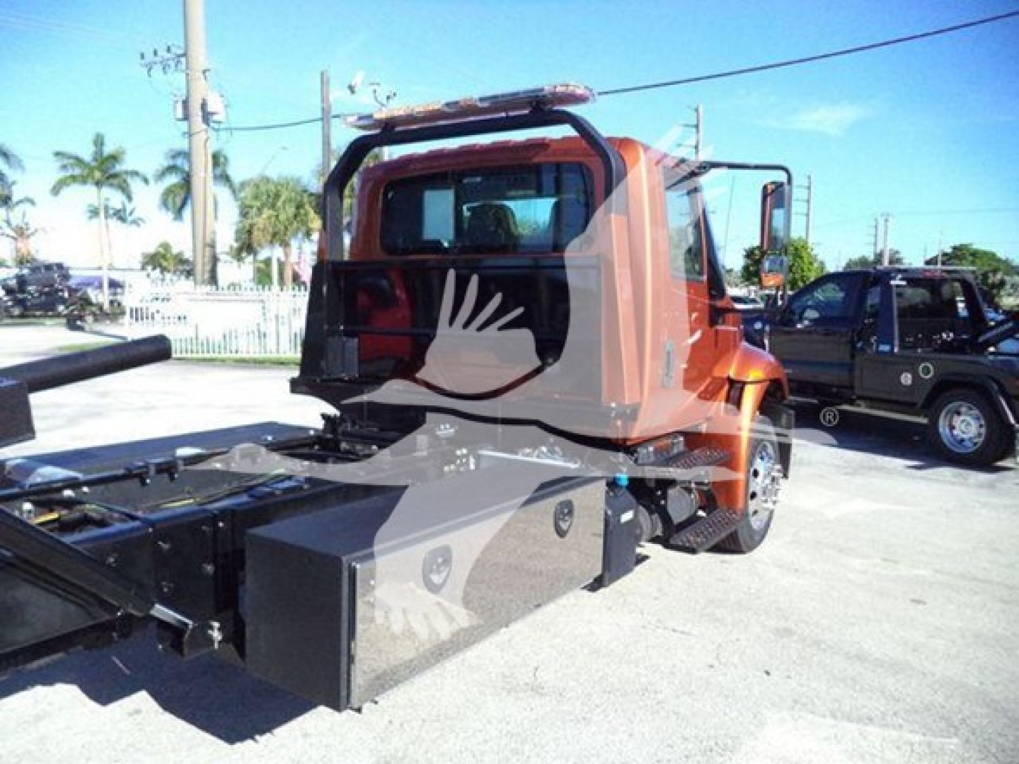 Truck cab and rollback bed showing storage box and metal framework on a 2019 International Durastar 4300 rollback truck.