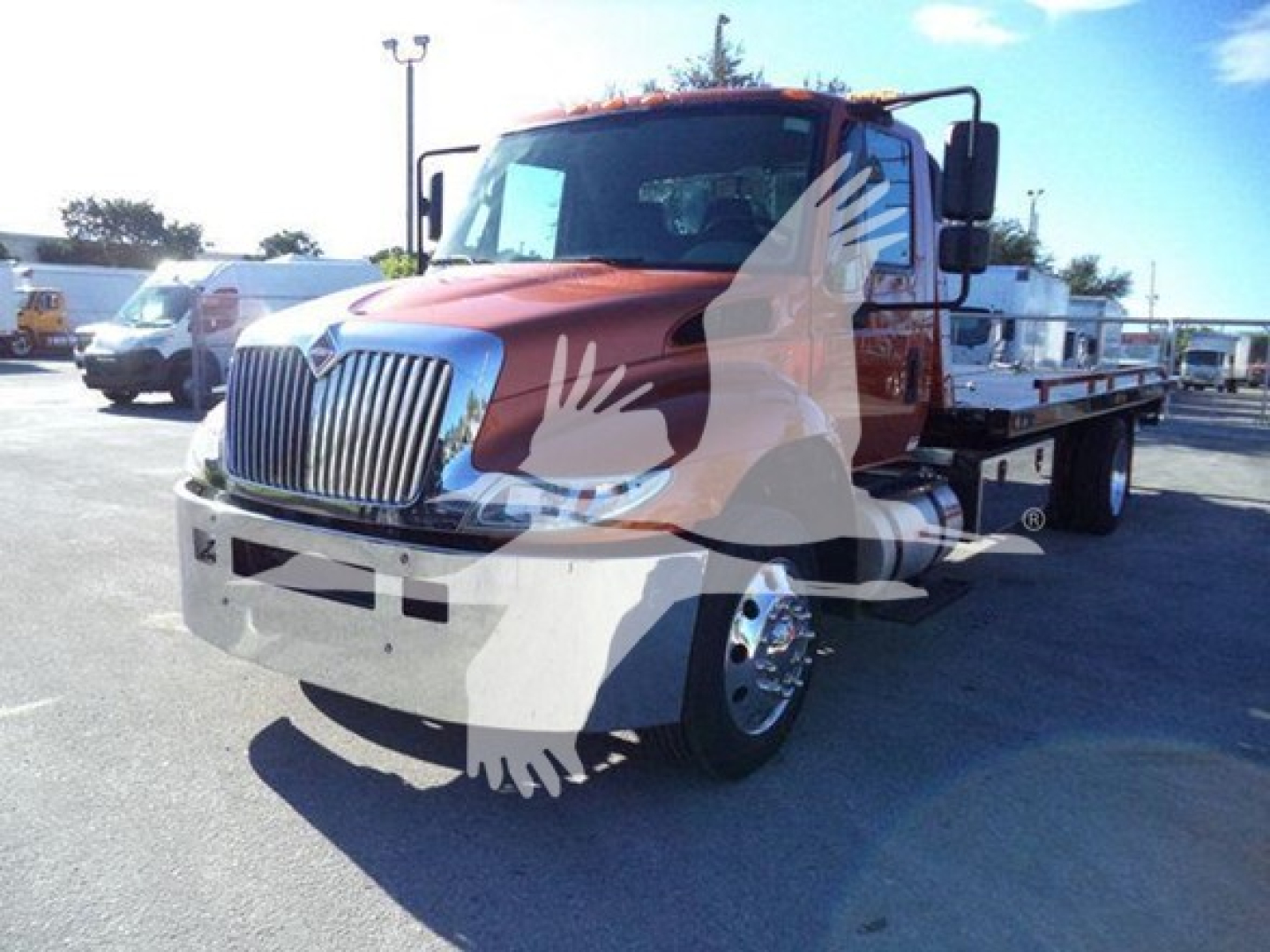 Truck in a lot showing a red International Durastar 4300 rollback with chrome grille; visible text includes VIN 1HTMMMML7KH520494 on listing, stock number T20494.