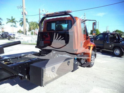 Truck cab and rollback bed showing storage box and metal framework on a 2019 International Durastar 4300 rollback truck.