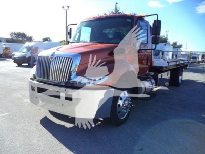 Truck in a lot showing a red International Durastar 4300 rollback with chrome grille; visible text includes VIN 1HTMMMML7KH520494 on listing, stock number T20494.