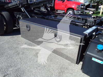 Truck tool/utility bed with diamond-plate toolbox mounted on rollback chassis, side view showing storage box and tanks