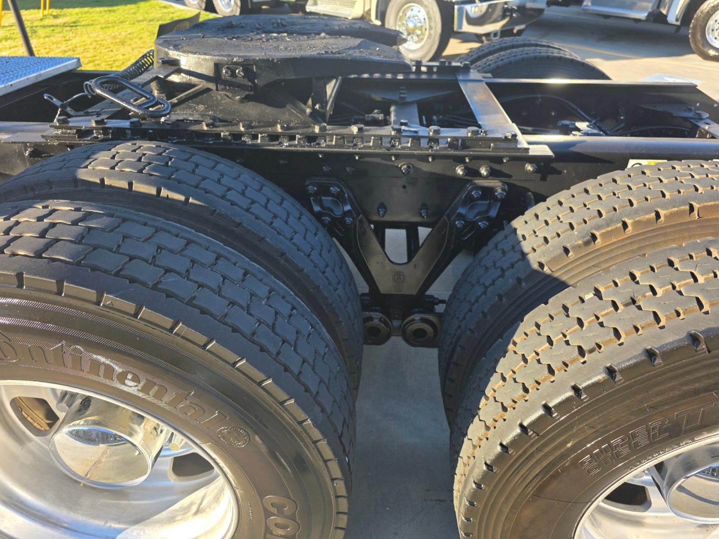 Kenworth T880 chassis showing dual rear axles and suspension components with large tires