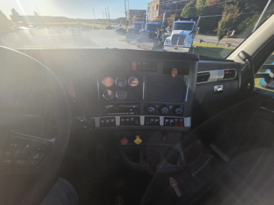 Kenworth T880 cab interior dashboard and steering wheel view with control panels and gauges visible