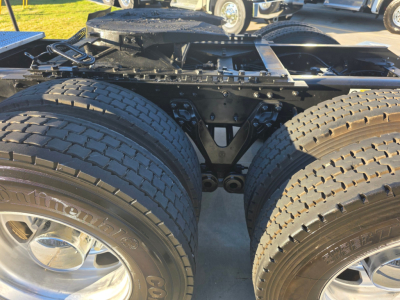 Kenworth T880 chassis showing dual rear axles and suspension components with large tires