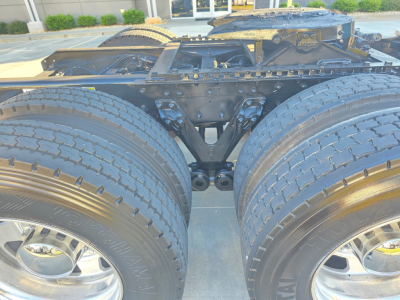Kenworth T880 dual rear axle chassis showing rear frame and suspension components with dual tires and wheels.