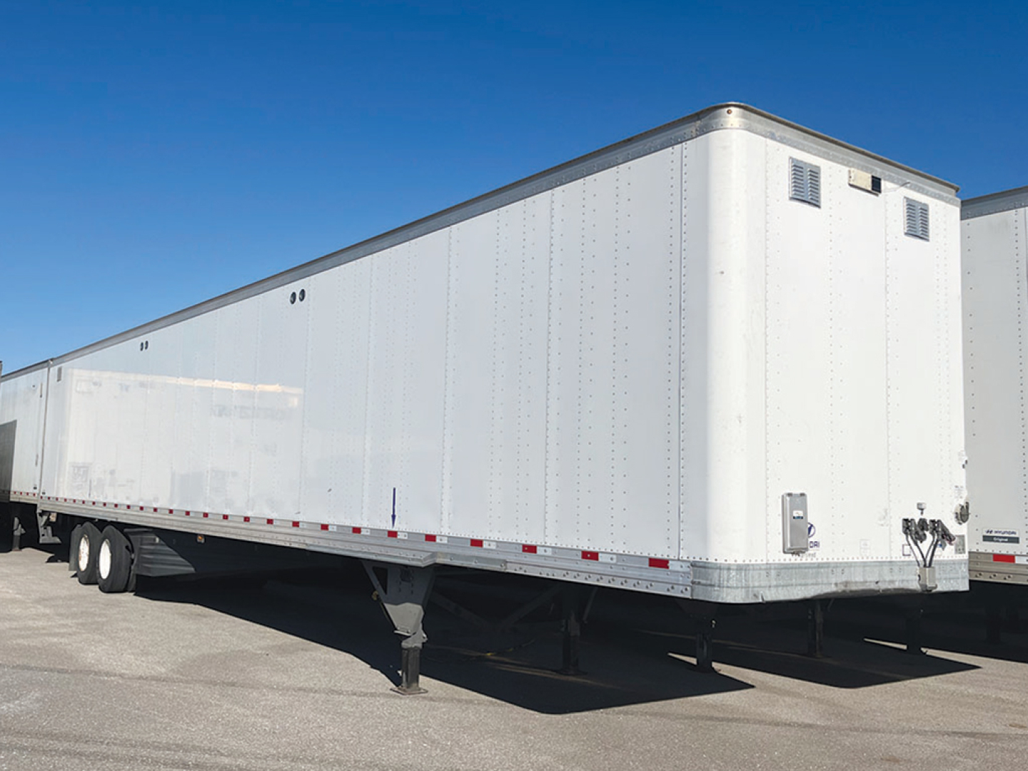 Hyundai aluminum dry van trailer in profile showing side panels and front corner with ventilation louvers.