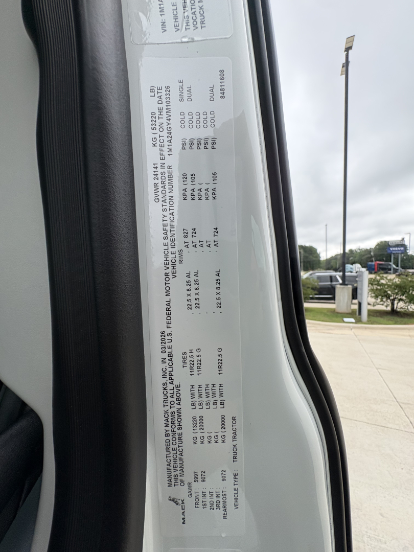 VIN/vehicle information sticker on door jamb with specs such as GVWR, payload, axle ratings, engine family, and tire information.