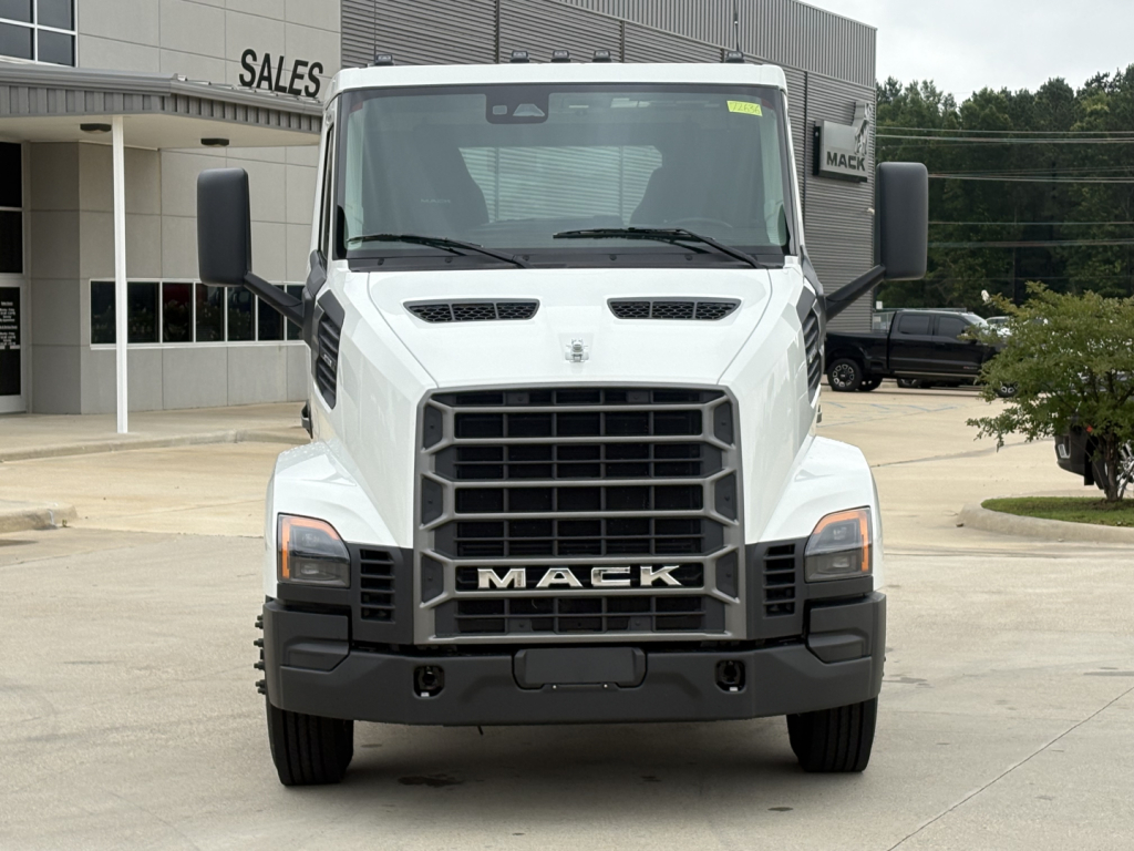 Truck front view showing Mack grille, 'MACK' emblem, large grill, headlights, and side mirrors.
