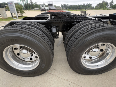 Mack AN64T truck chassis showing dual rear axles and tires, wheel rims, and mounting frame.