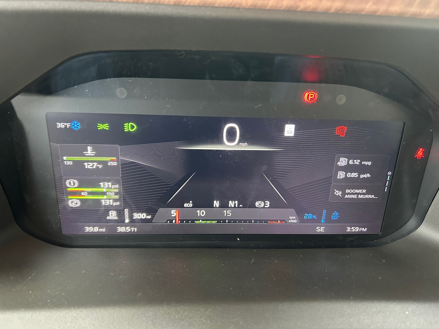 Volvo VNL dashboard display showing digital speedometer at 0 mph and multiple gauges, warning icons, and trip data.