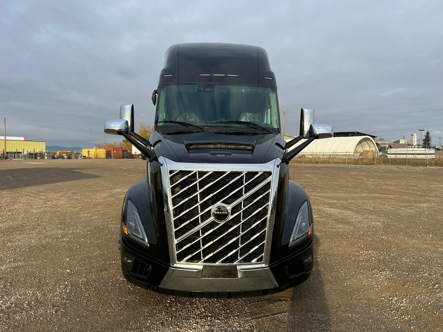 Volvo VNL64T660 truck front view showing distinctive chrome grille, large windshield, and side mirrors.