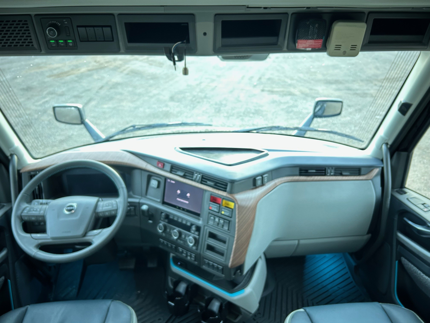 Volvo VNL64T660 interior cab view with steering wheel and dashboard.