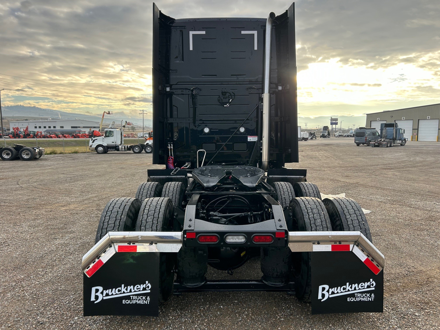Volvo VNL64T660 tractor rear view showing dual rear axles, fifth wheel, and mudflaps with Bruckner's Truck & Equipment branding.