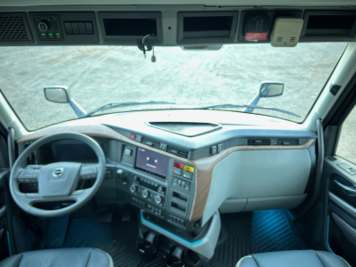 Volvo VNL64T660 interior cab view with steering wheel and dashboard.