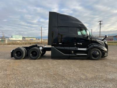 Volvo VNL64T660 tractor unit side view showing cab and chassis with sleeper, black paint, no visible decals.