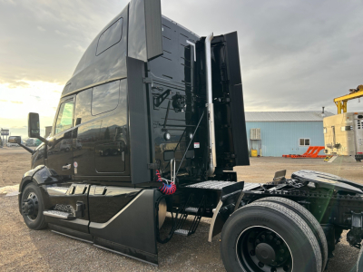 Volvo VNL64T660 truck tractor side view showing sleeper cab and chassis with rear cab access and fender.