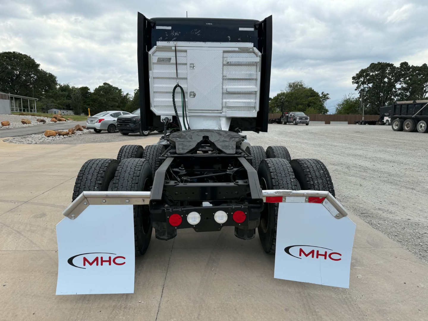 Kenworth T680 rear view showing fifth wheel, dual rear axles, mudflaps with MHC logo, and white tail area; stock number 0631429 visible.