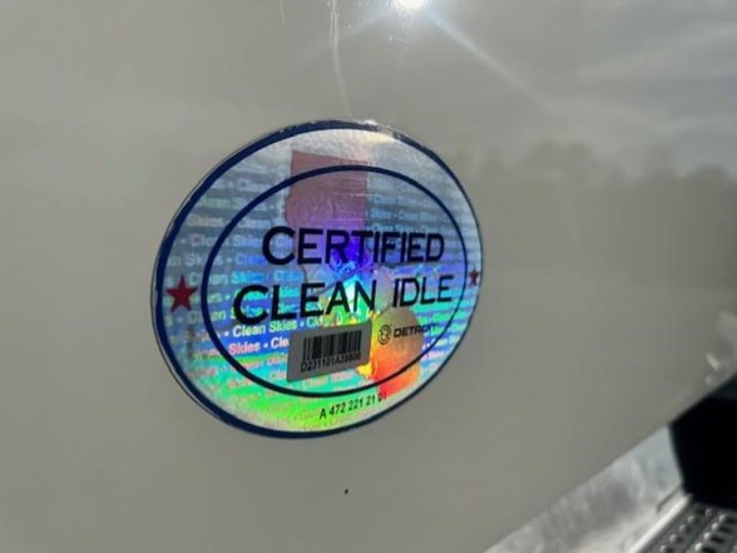 Sticker on vehicle showing 'CERTIFIED CLEAN IDLE' with holographic background.