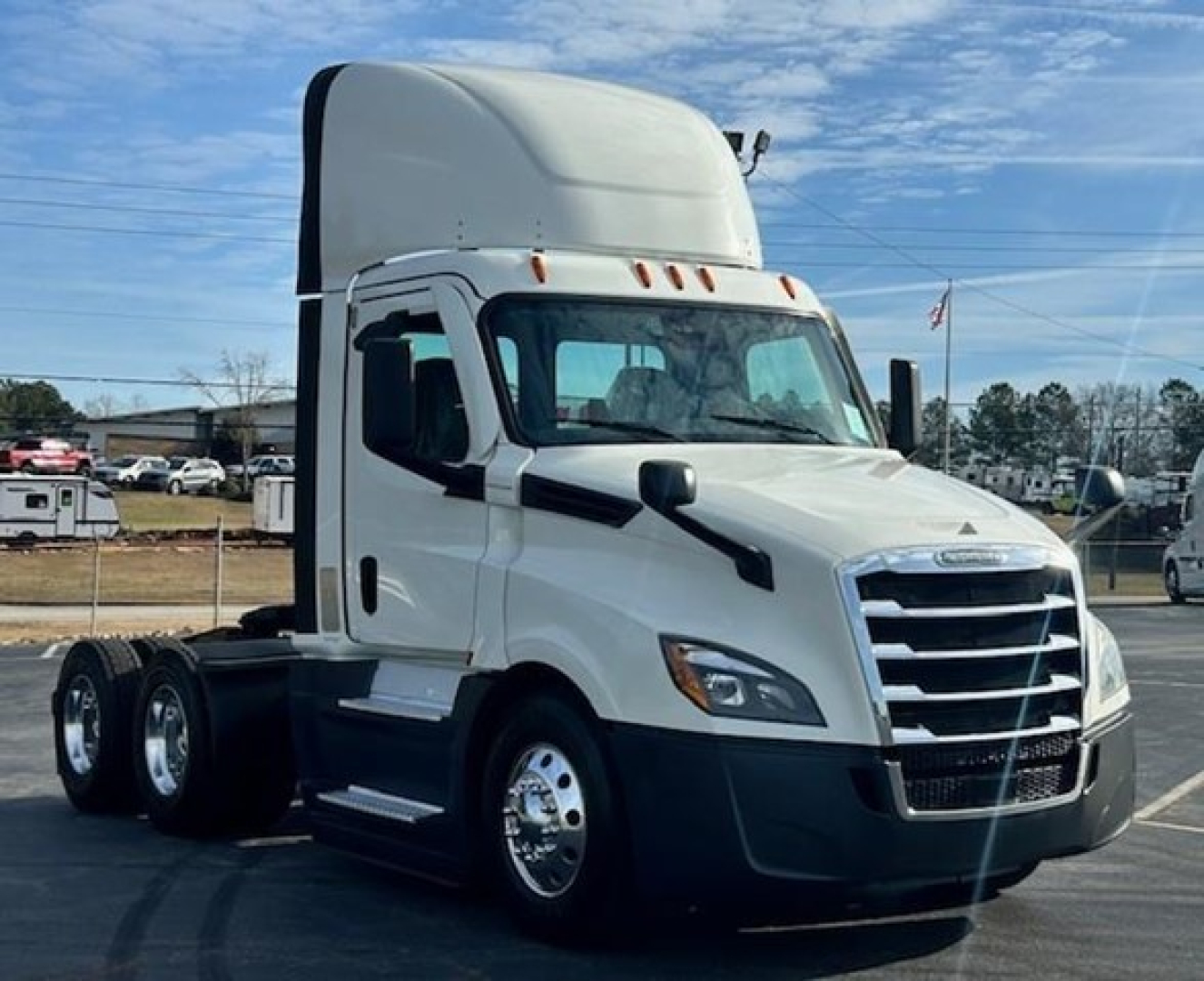 Freightliner Cascadia 126 day cab tractor in white, front and left-side view, with sleeper cab raised, no visible text