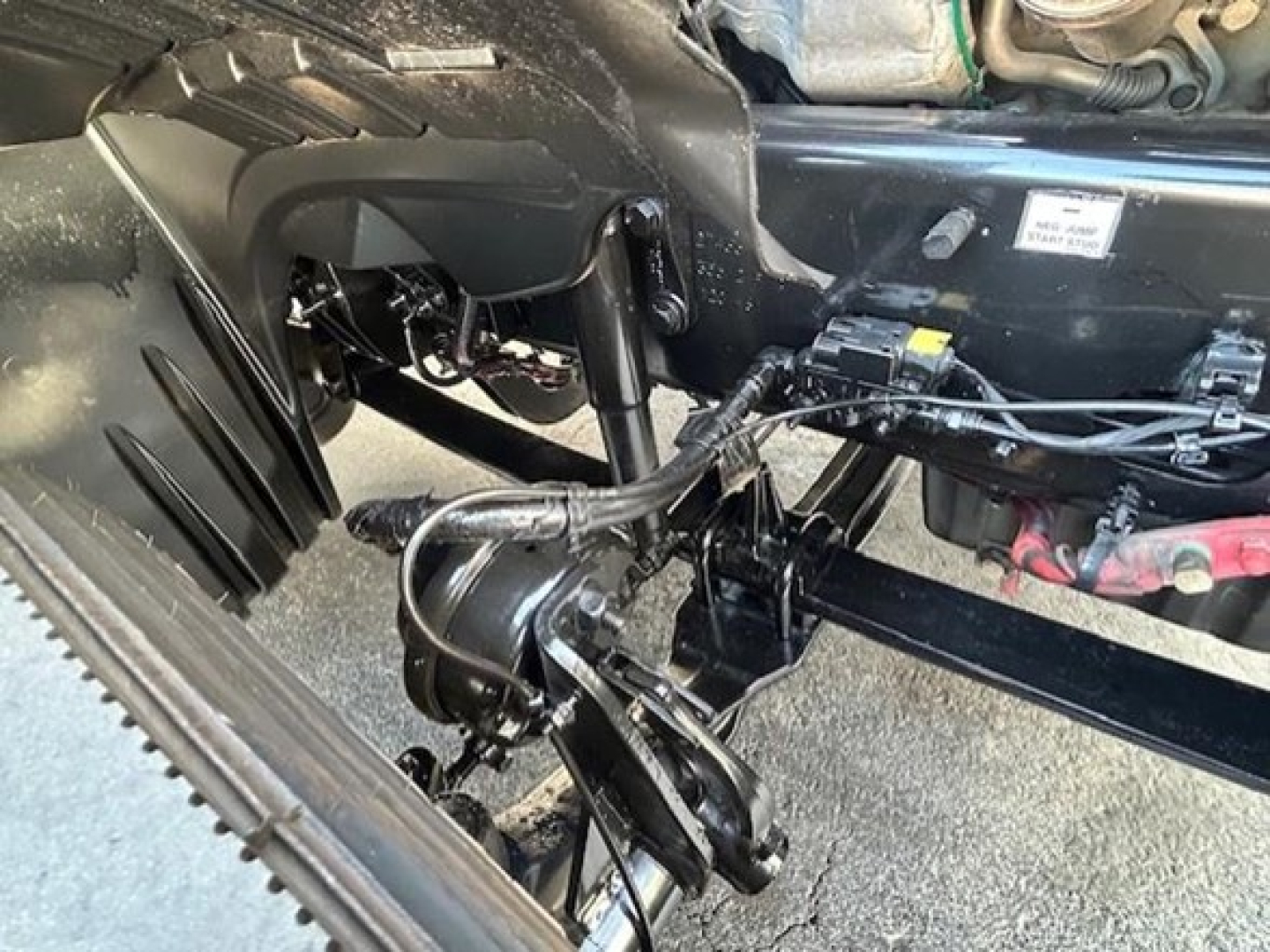 Freightliner Cascadia 126 engine bay showing steering linkage and under-cab components.