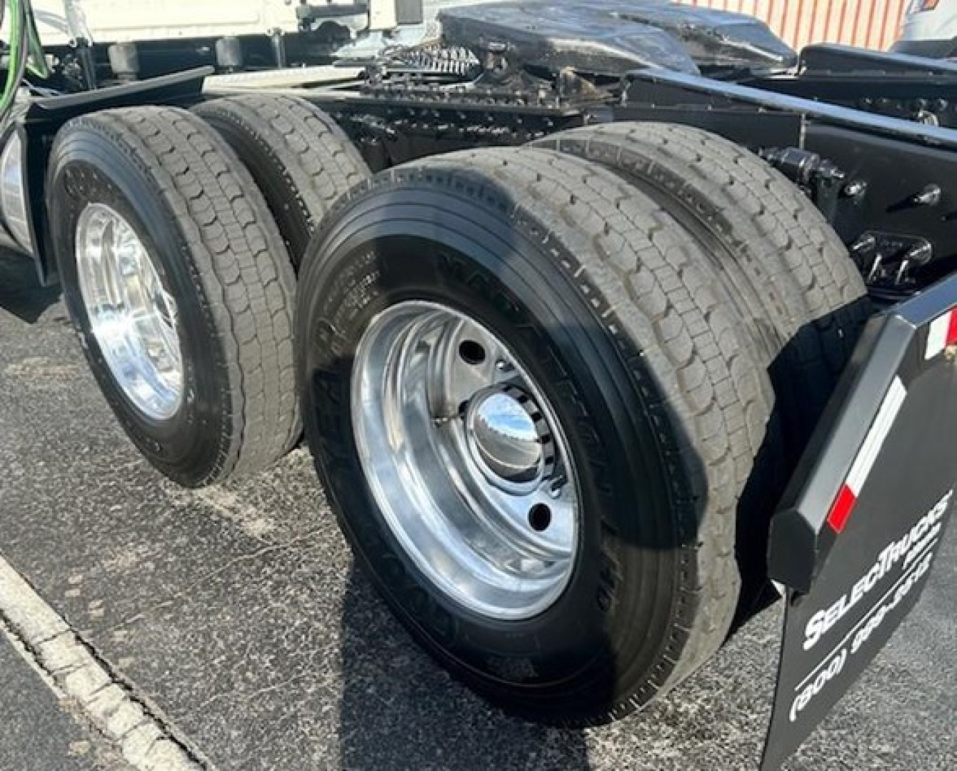 Freightliner Cascadia 126 rear wheels showing dual axle tires and chrome rims with hitch area visible.