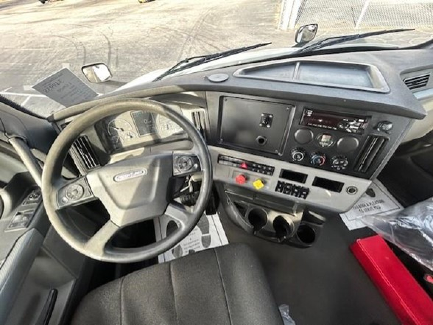 Freightliner Cascadia dash and steering wheel showing instrument panel and controls.