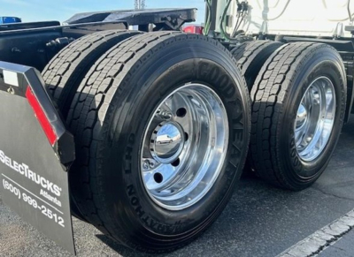 Truck rear wheels and tires showing dual axles on Freightliner Cascadia cab chassis.