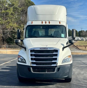 Front view of a white Freightliner Cascadia 126 day cab truck with large grille, black bumper, and side mirrors.