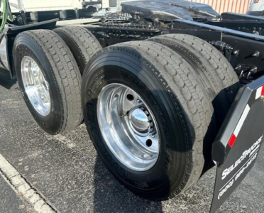 Freightliner Cascadia 126 rear wheels showing dual axle tires and chrome rims with hitch area visible.