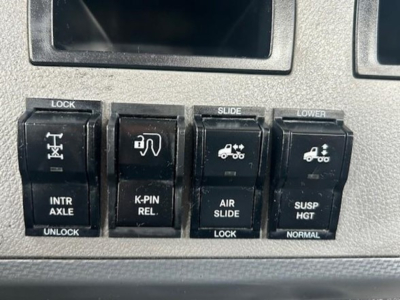 Dashboard switches with lock, slide, lower, intra axle, K-PIN release, air slide, suspension height labels.