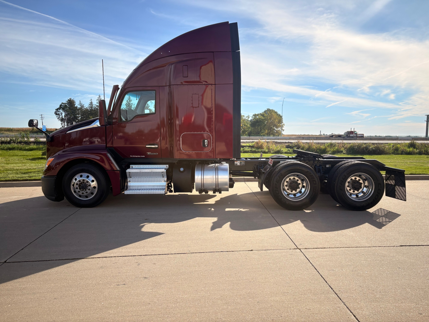 Kenworth T680 Conventional Sleeper tractor-trailer side view showing long hood and dual rear axles with fuel tanks.