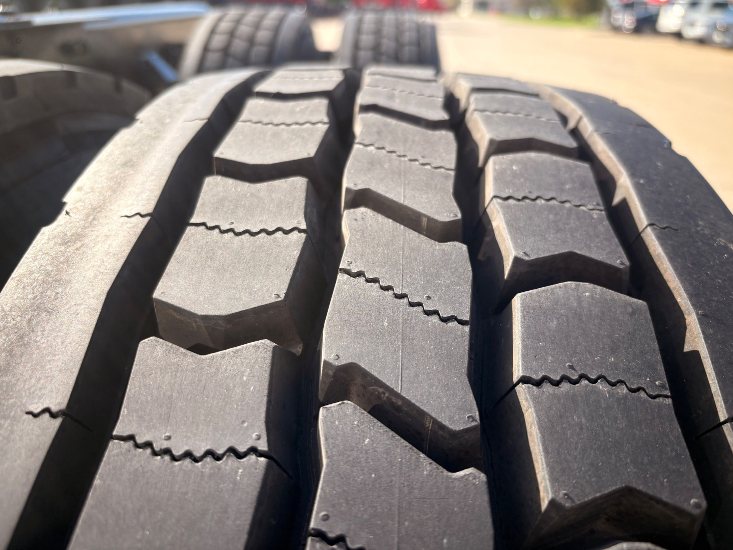 Tire tread close-up on Kenworth T680 pickup showing large block tread pattern