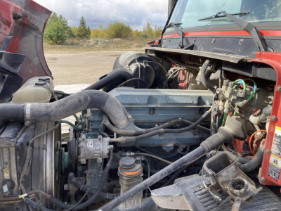 Engine bay of a Volvo S60 DD 2000 truck showing hoses, belts, and componentry in view.