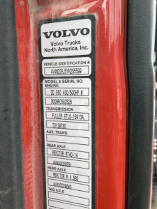 Volvo DD S60 truck door badge showing Vehicle Identification Number and model/serial labels with engine, transmission, rear axle data.