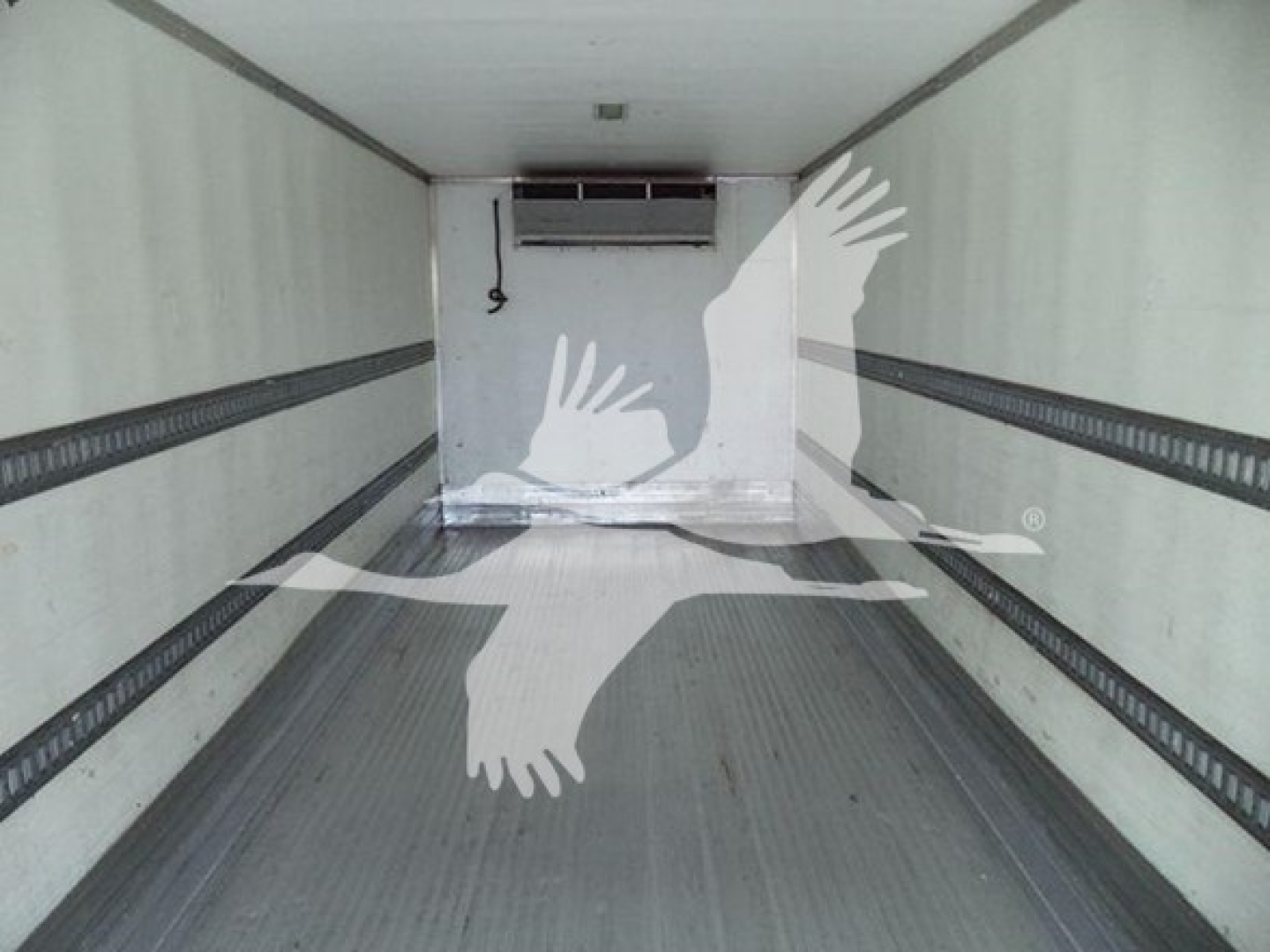 Interior view of a refrigerated 2019 International Durastar 4300 box truck cargo area with side tie rails and an HVAC unit near the front wall.