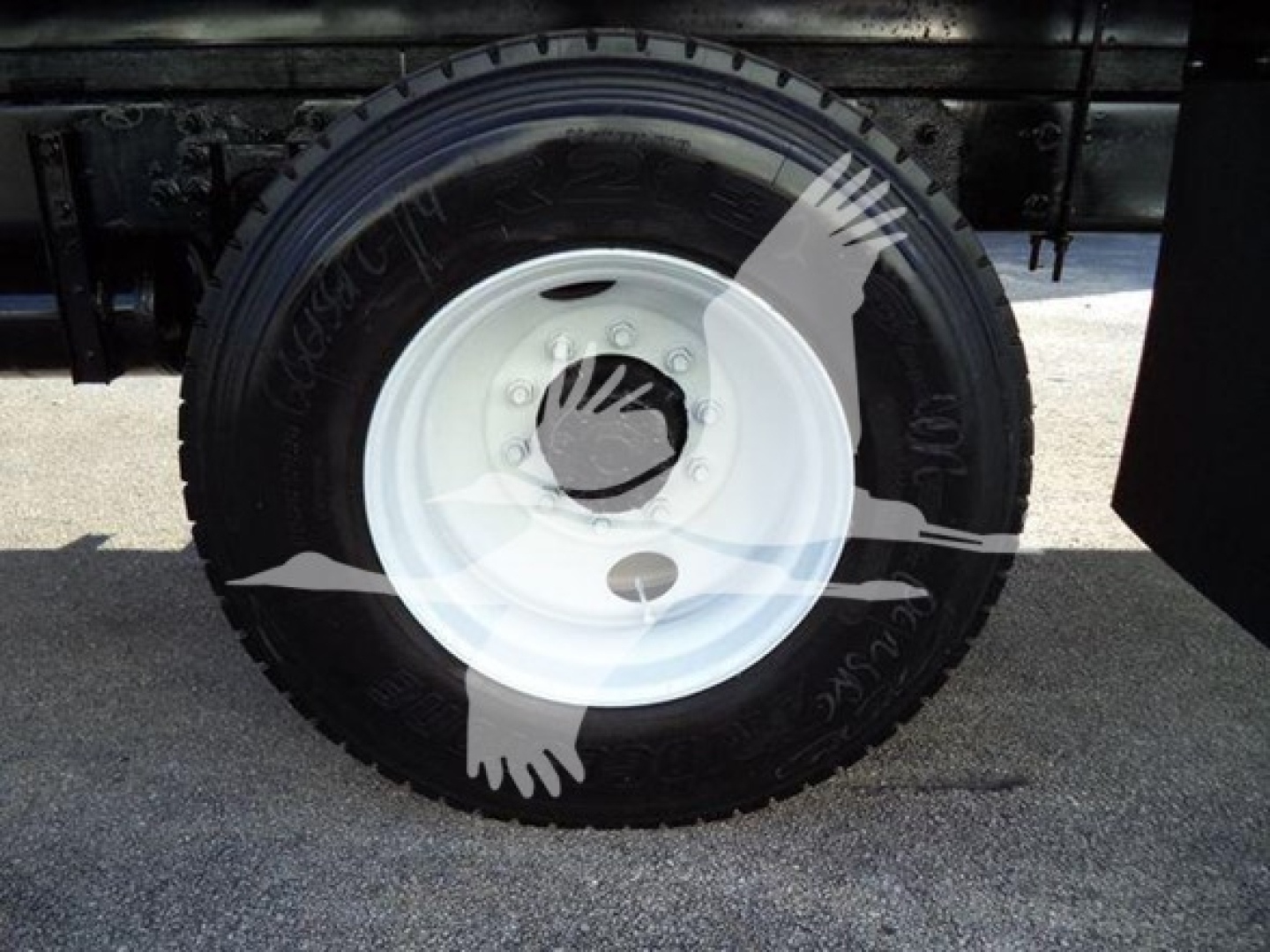 Wheel and tire of a refrigerated 2019 International Durastar 4300 truck showing white steel rim and tire sidewall