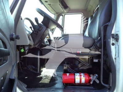 Interior of a 2019 International Durastar 4300 truck with steering wheel, driver's seat, and a red fire extinguisher in the cabin.