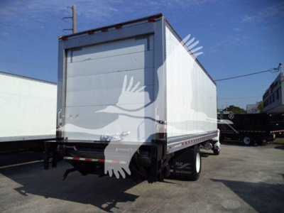 Rear/side view of a refrigerated box truck with a white box, black chassis, and dual rear doors. There is a small cab visible, with a black front bumper and wheel wells.