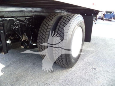 Truck rear dual wheels and undercarriage of a 2019 International Durastar 4300 refrigerated truck showing dual rear tires and frame.