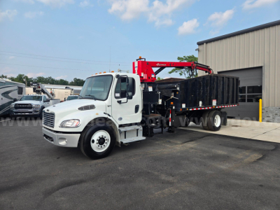 2019 Freightliner M2 grapple truck with a red crane arm on a black flatbed. White cab, side mirrors, large front grille, stock number 29174-85 visible.