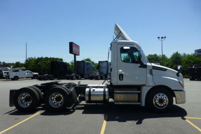 Freightliner Cascadia day cab truck side view showing chassis and cab with white paint.