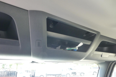 Freightliner Cascadia cab interior showing overhead storage compartment with open panel and wires visible.