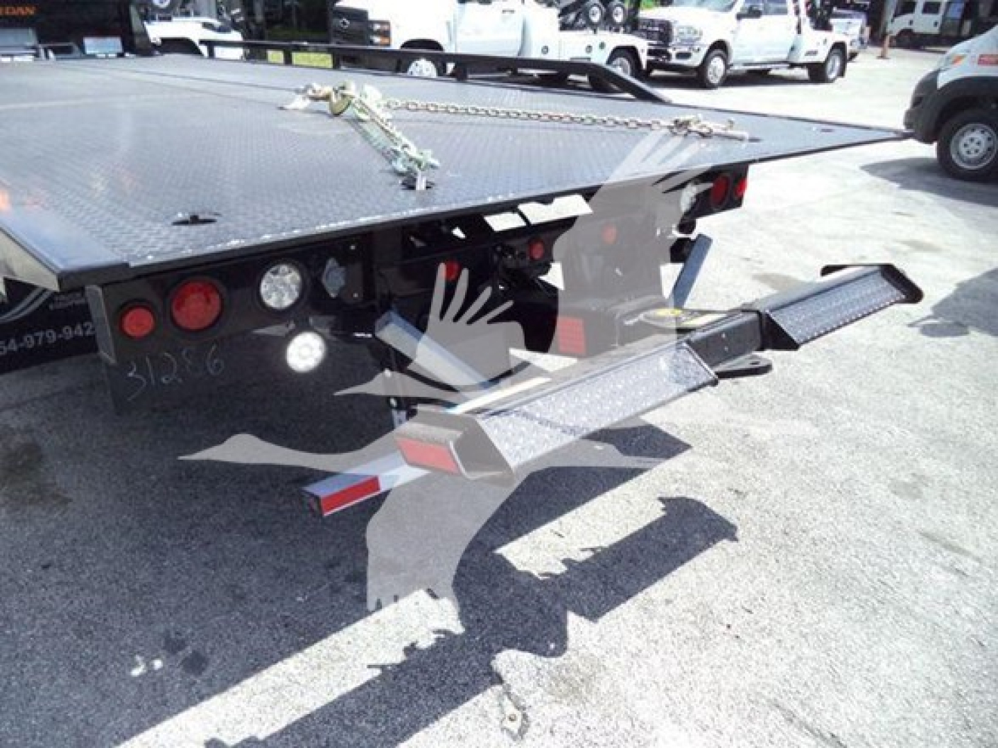 Ram 5500 rollback tow truck bed rear with hydraulic ramps; visible stickers: VIN 3C7WRMDL0RG240687, stock J40687, Category Rollback, Type Trucks, New Used New.