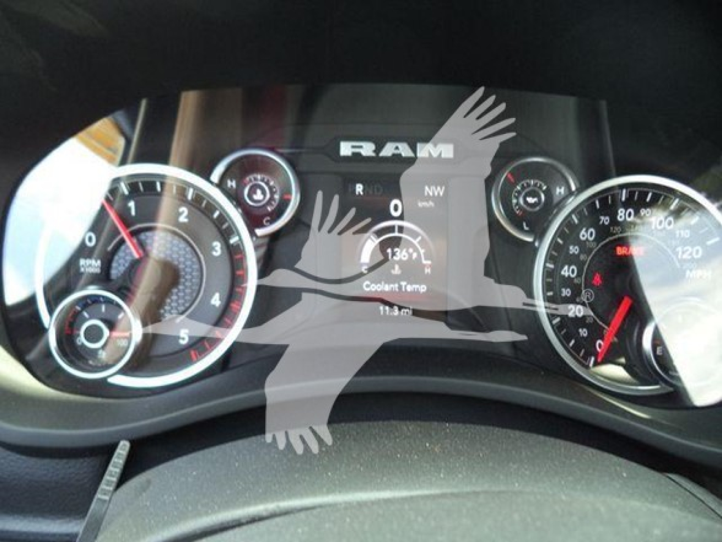 Ram 1500/5500 gauge cluster view showing speedometer and tachometer with RAM logo watermark over image