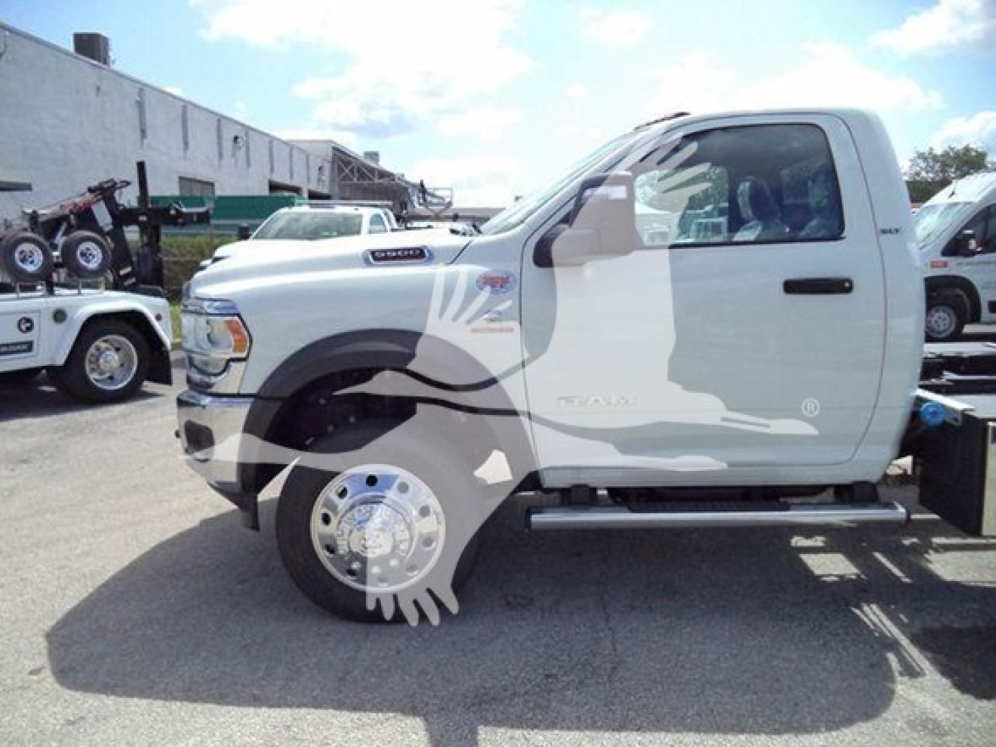 Ram 5500 SLT single cab side view showing truck cab and front wheel, white with graphics.