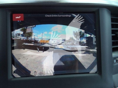 Display screen showing camera view with reflected hands; text reads 'Check Entire Surroundings' on the Ram 5500 dashboard area.