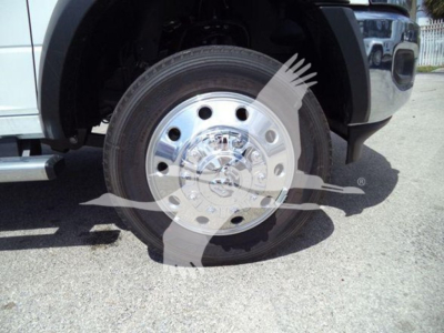 Front wheel and fender of a 2024 Ram 5500 SLT with chrome steel wheel and tread visible.