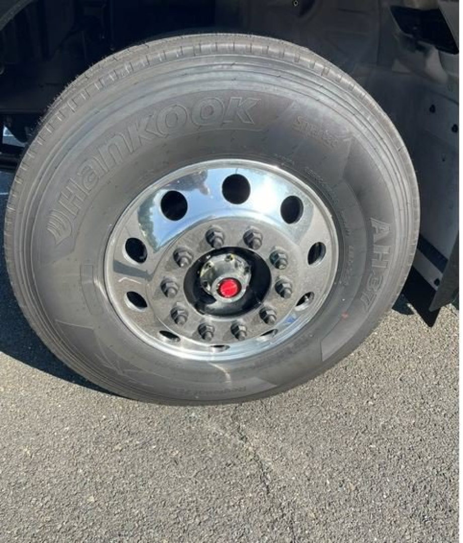 Hino L7 wheel showing Hankook tire and steel wheel with lug nuts and red center cap.