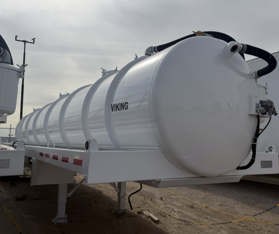 Trailer-mounted vacuum tank labeled VIKING with rounded cylindrical tank on a trailer frame, hose connections and support legs visible.